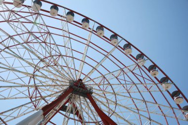 Beautiful large Ferris wheel against blue sky, low angle view