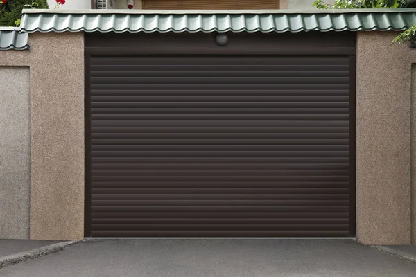 Building with brown roller shutter garage door