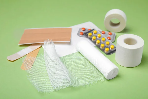 薄緑色の背景に白い包帯と医療用品 — ストック写真