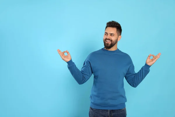 Young Man Meditating Light Blue Background Zen Concept — Stock Photo, Image