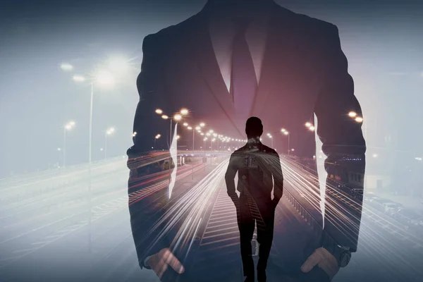 Double exposure of businessmen and highway in night. Leadership concept