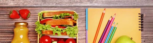 School meal. Lunch box with healthy food and different stationery on wooden table, flat lay. Banner design
