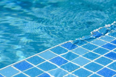 Clear refreshing water in swimming pool on sunny day, closeup