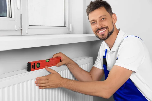 Professional Plumber Using Bubble Level Installing New Heating Radiator Room — Stock fotografie