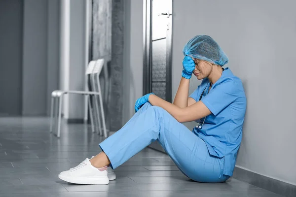 Exhausted Doctor Sitting Floor Hospital Space Text — Stock Fotó