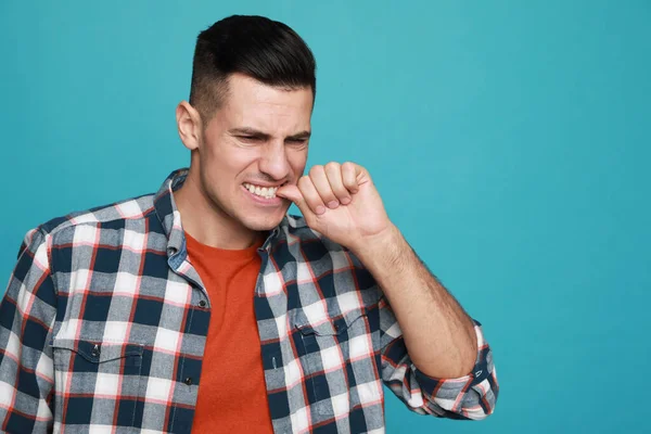 Man Biting His Nails Light Blue Background Space Text Bad — Stock Photo, Image