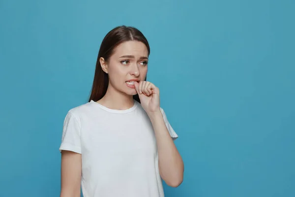 Young Woman Biting Her Nails Light Blue Background Space Text — Stock Photo, Image