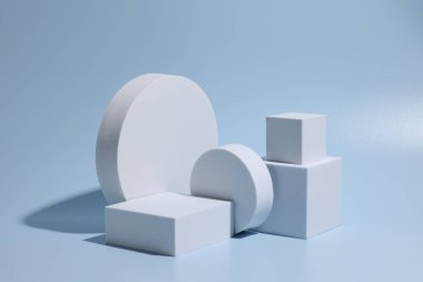 Ürün sunumu için sahne. Açık mavi arkaplanda farklı geometrik şekillerin podyumları