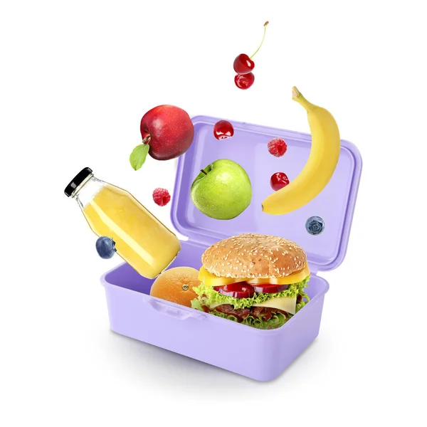 Different fresh food falling into lunch box on light background. School meal