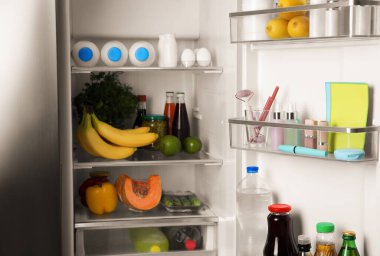 Storage of cosmetics in refrigerator door bin next to groceries