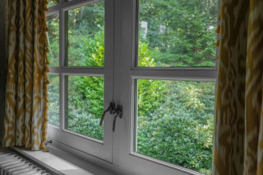 Old fashioned window with beautiful curtains in room. Interior design