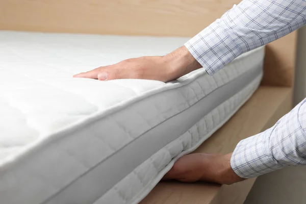 Man Touching Soft White Mattress Indoors Closeup — Stockfoto