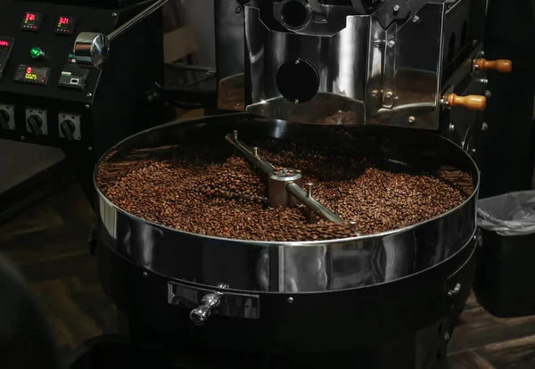 Modern coffee roaster machine with beans indoors