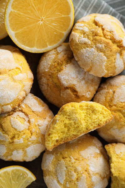 Delicious lemon cookies and citrus fruit on towel, closeup