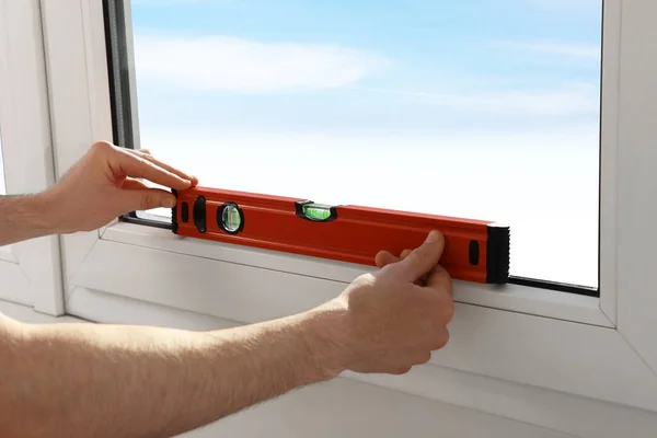 Worker Using Bubble Level Plastic Window Installation Indoors Closeup — Stockfoto