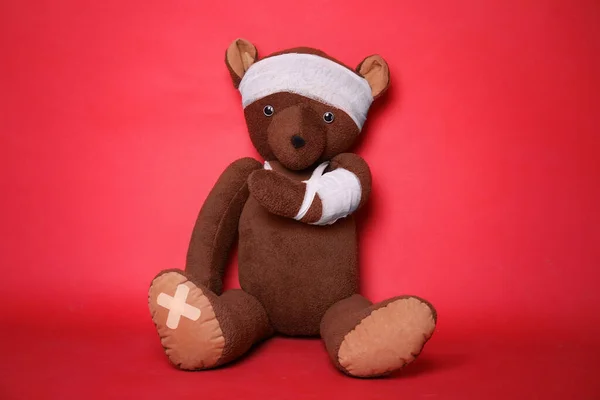 Toy Bear Bandages Red Background — Stock Photo, Image