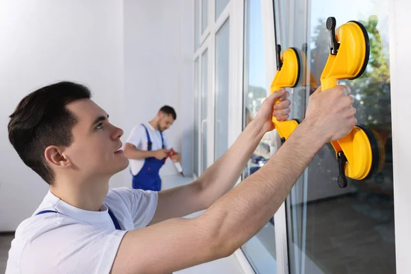 Worker Using Suction Lifters Plastic Window Installation Indoors — Stockfoto