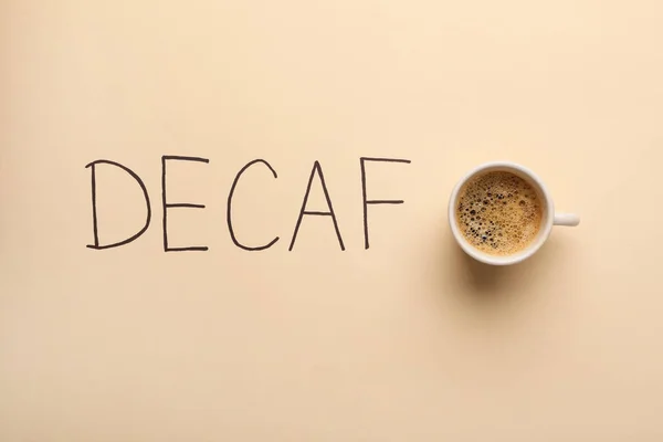 Cup Aromatic Coffee Word Decaf Beige Background Top View — Stockfoto