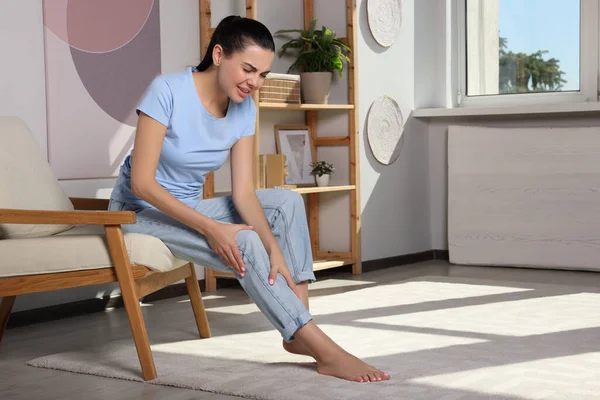 Young Woman Rubbing Sore Leg Home Space Text —  Fotos de Stock