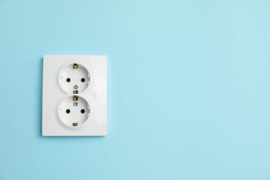 Açık mavi duvarda çift güç prizi, mesaj için boşluk. Elektrik arzı