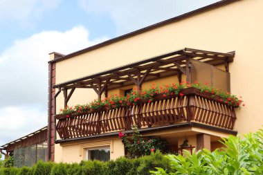 Ahşap balkon. Çiçeklerle süslenmiş.