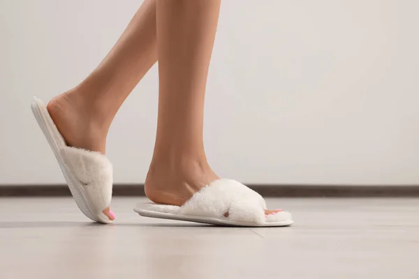 Woman Wearing White Soft Slippers Indoors Closeup Space Text — стоковое фото