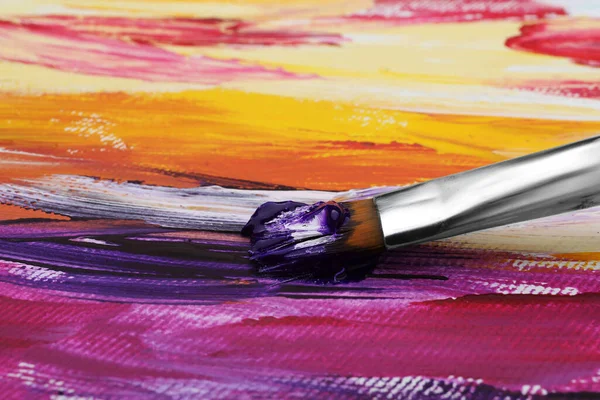 Painting with colorful oil paints on white canvas, closeup view