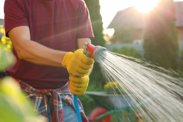 Man Watering Plants Hose Outdoors Sunny Day Closeup Gardening Time — Stock Photo, Image