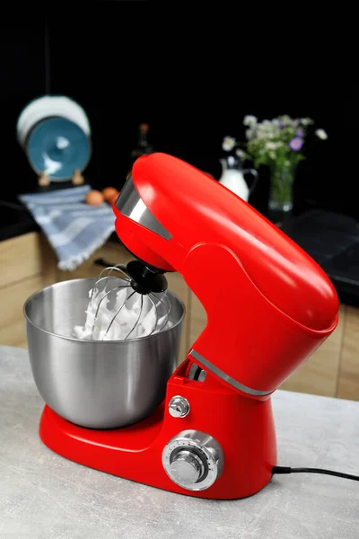 Modern stand mixer on table in kitchen. Home appliance