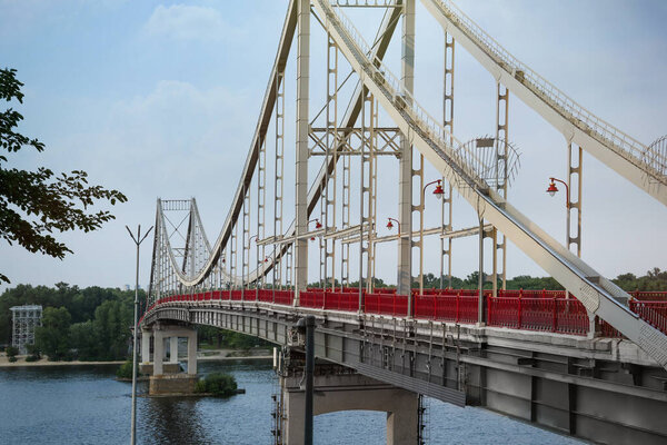 KYIV, UKRAINE - AUGUST 11, 2022: Beautiful view of modern pedestrian Park bridge over Dnipro river
