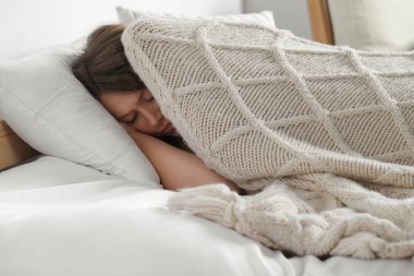 Sleepless young woman in bed at home