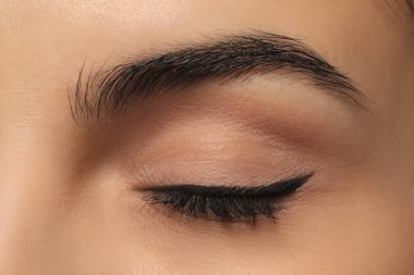Young woman with permanent eyeliner makeup, closeup