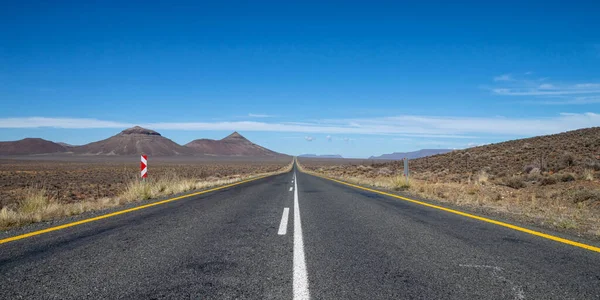 An empty road stretches into the distance in the Northern Cape, South Africa