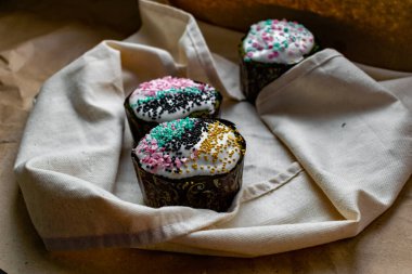 Paskalya Bayramı ev yapımı Paskalya pastaları, üzerine beyaz eggnog kreması serpiştirilmiş renkli Paskalya pastaları, Paskalya bayramı için tatlı geleneksel pastalar, Ortodoks un yemeğinin süslemeleri.