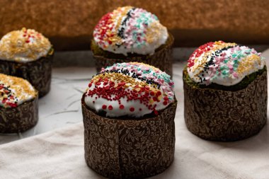 Paskalya Bayramı ev yapımı Paskalya pastaları, üzerine beyaz eggnog kreması serpiştirilmiş renkli Paskalya pastaları, Paskalya bayramı için tatlı geleneksel pastalar, Ortodoks un yemeğinin süslemeleri.