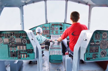 Young pilots inside the helicopter clipart