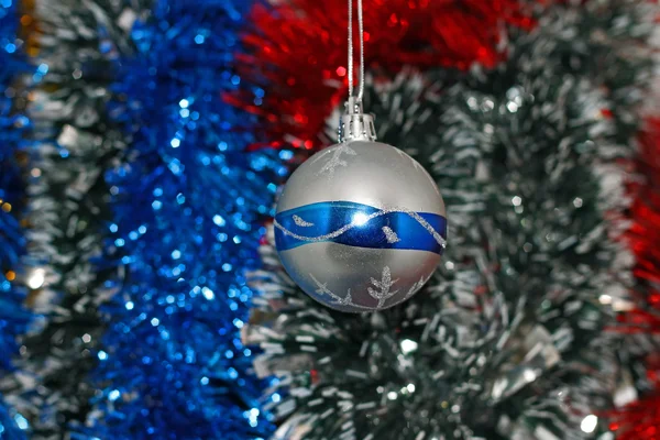 Christmas toy against the background of new year's tinsel — Stock Photo, Image