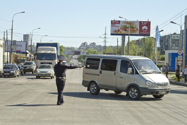 Police road service regulate traffic with a rod.