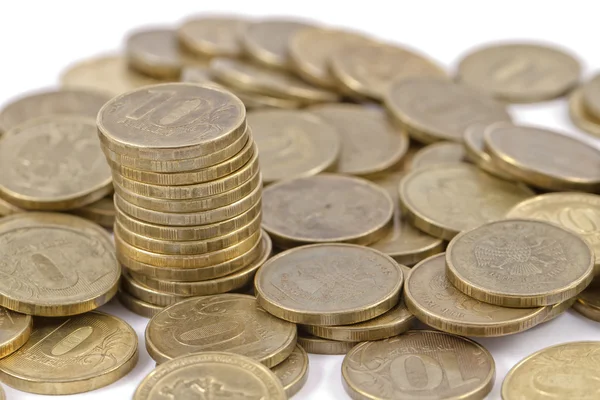 Stack of gold coins among scattering coins — Stock Photo, Image