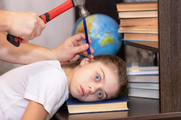 Middle school student is hammered knowledge from books with a hammer