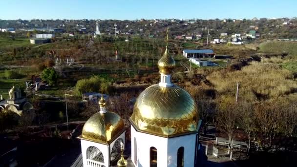 Orthodox church with white camps, bell tower and gilded domes — Stock Video