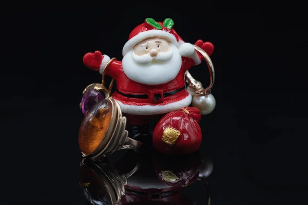 Toy Santa Claus Holds Gold Jewelry Gifts — Stock Photo, Image