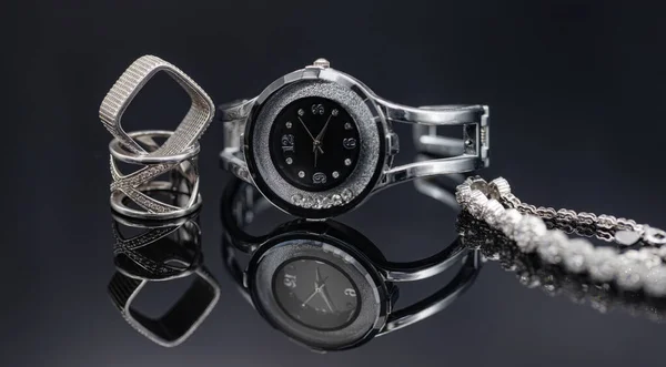 Κομψό γυναικεία ρολόγια σε μια μεταλλική θήκη και κοσμήματα από ασήμι — Φωτογραφία Αρχείου