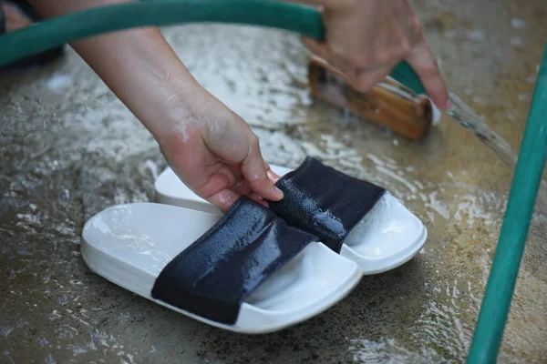Clean the shoes with water by hand.
