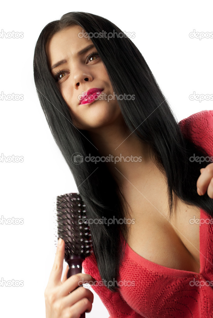 Portrait of the beautiful girl with a hairbrush