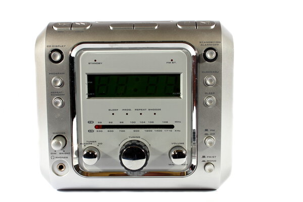 Isolated silver digital alarm clock with radio and CD player.
