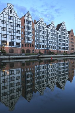 Gdansk in Poland, half-timbered houses are reflected in the river Motlawa clipart