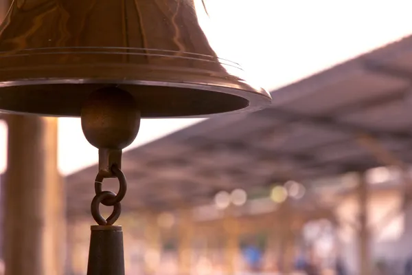 Old bell in train station with sunrise light