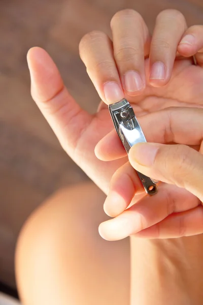 Hand manicure with nail clipper — Stock Photo, Image