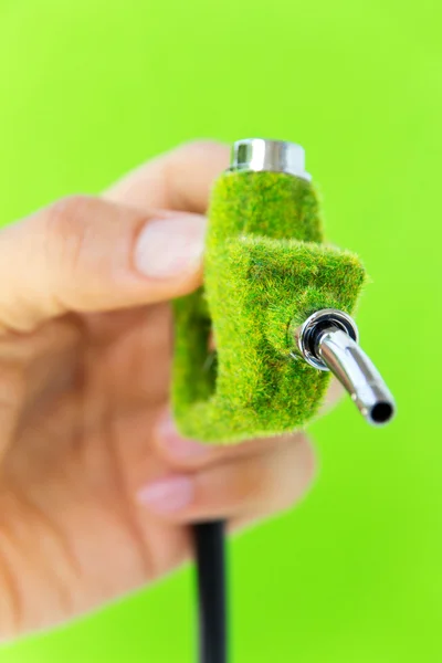 Hand holding eco fuel nozzle — Stock Photo, Image